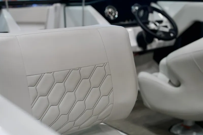 Slide: The Image of 2026 Four Winns H2 boat interior with white leather seats and modern steering wheel. - 15
