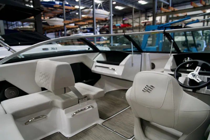 Slide: The Image of 2026 Four Winns H2 boat interior with modern seating and steering wheel. - 16