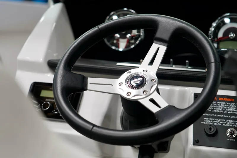 Slide: The Image of Steering wheel of 2026 Four Winns H2 boat, featuring sleek design and control panel. - 17