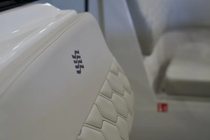 Slide: The Image of 2026 Four Winns H2 boat interior with white quilted upholstery and logo detail. - 19