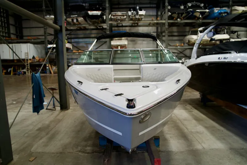 Slide: The Image of 2026 Four Winns H2 boat in a storage facility, showcasing sleek design and modern features. - 2
