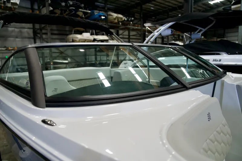 Slide: The Image of 2026 Four Winns H2 boat in showroom, featuring sleek design and modern interior. - 21