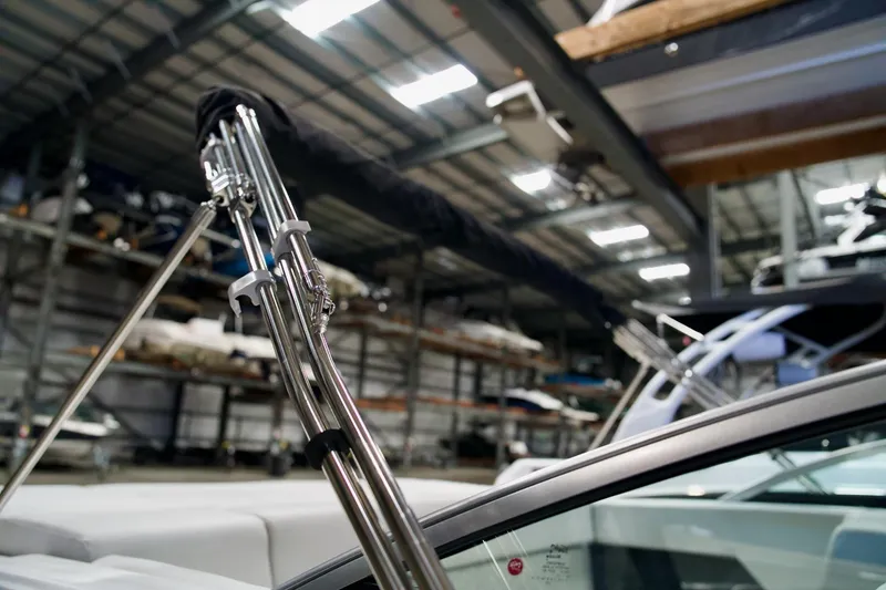 Slide: The Image of 2026 Four Winns H2 boat in storage, showcasing sleek metal framework and modern design. - 22