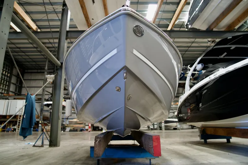 Slide: The Image of 2026 Four Winns H2 boat in a warehouse, viewed from the front. - 4