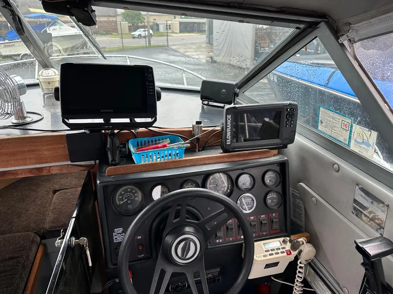 Slide: The Image of Interior of a 1990 Crestliner 21 Sabre boat with navigation equipment and steering wheel. - 4