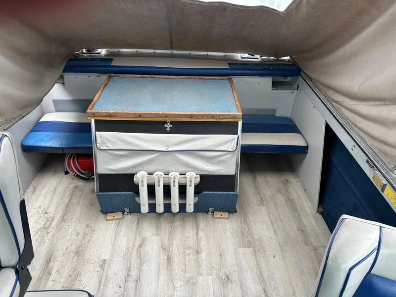 Slide: The Image of Interior of a 1990 Crestliner 21 Sabre boat with seating and storage. - 5