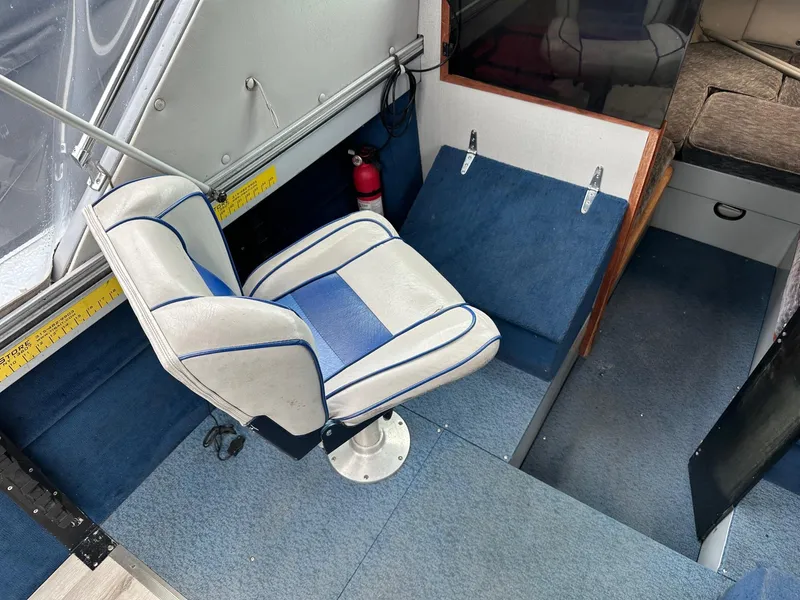 Slide: The Image of Interior of 1990 Crestliner 21 Sabre boat with blue and white seating. - 6