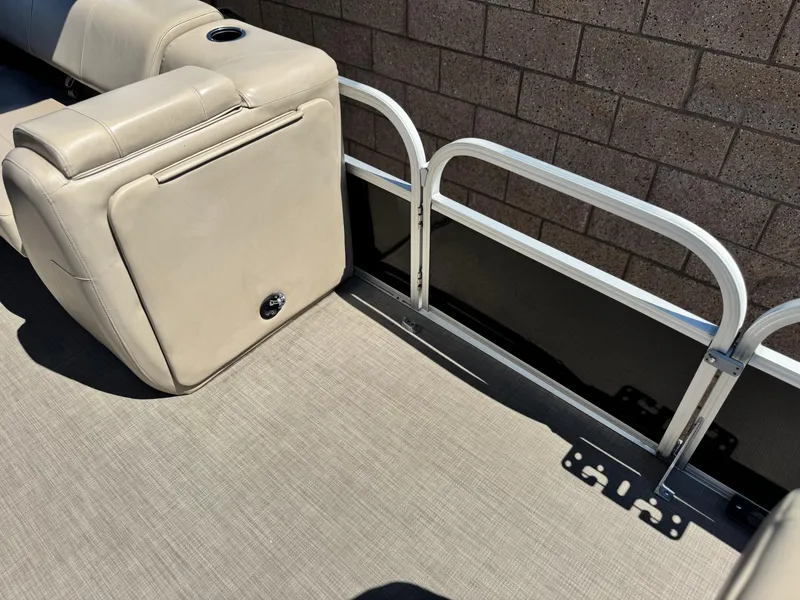 Slide: The Image of 2019 Sun Tracker Fishin' Barge 20 DLX interior with beige seating and metal railing. - 11