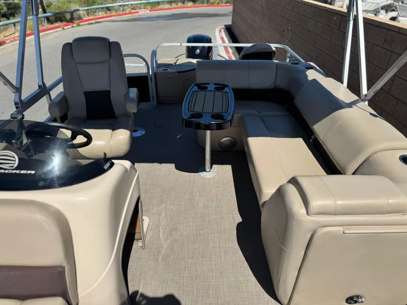 Slide: The Image of 2019 Sun Tracker Fishin' Barge 20 DLX interior with beige seating and steering console. - 12