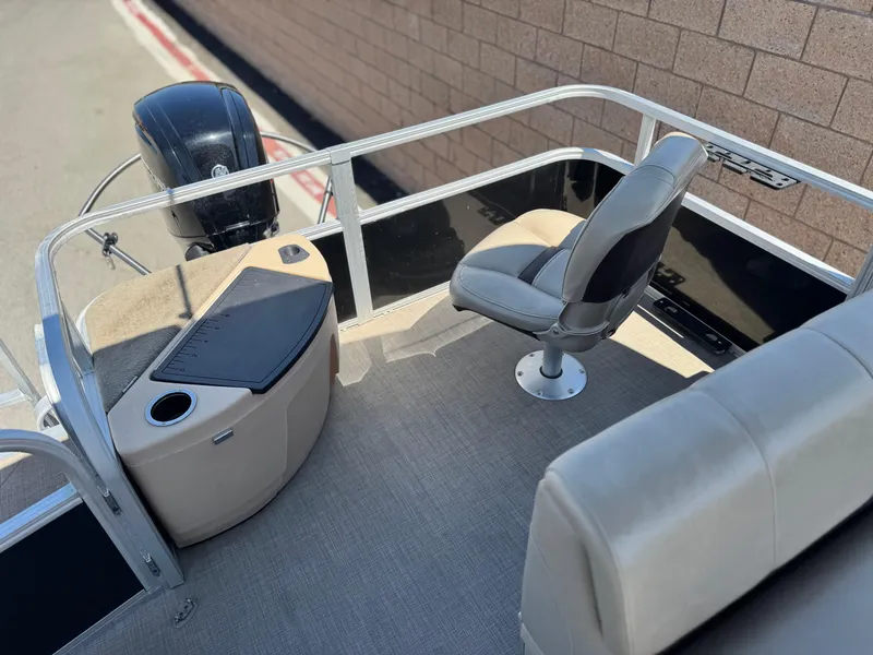 Slide: The Image of 2019 Sun Tracker Fishin' Barge 20 DLX interior with seating and motor. - 14