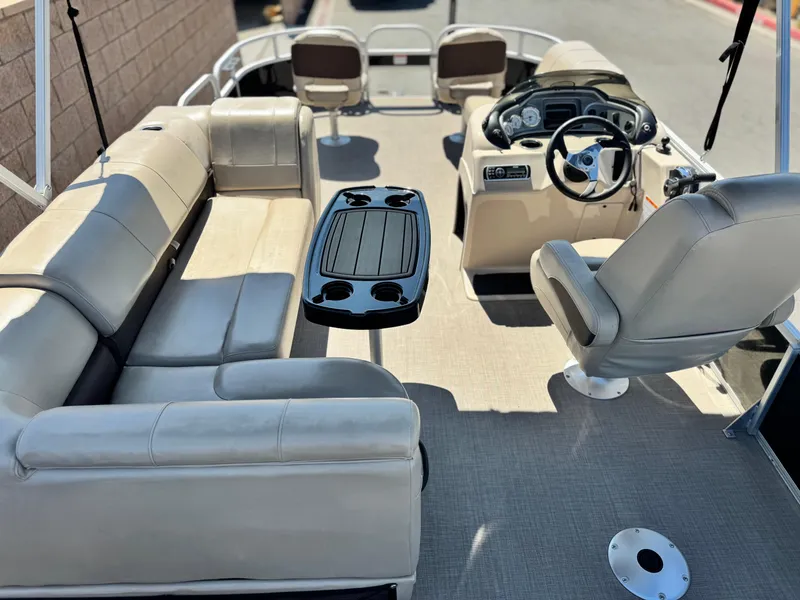 Slide: The Image of 2019 Sun Tracker Fishin' Barge 20 DLX interior with seating and steering console. - 17