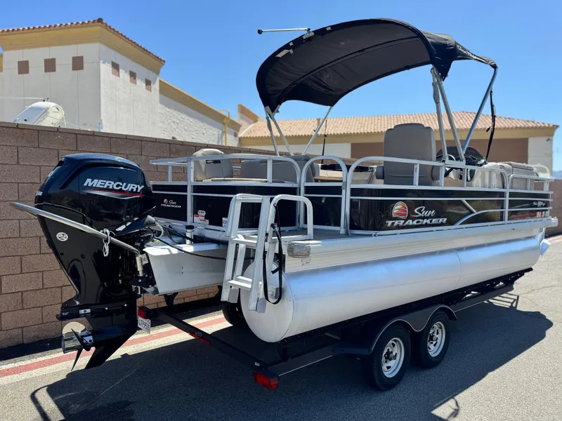 Slide: The Image of 2019 Sun Tracker Fishin' Barge 20 DLX pontoon boat with Mercury engine on trailer. - 5