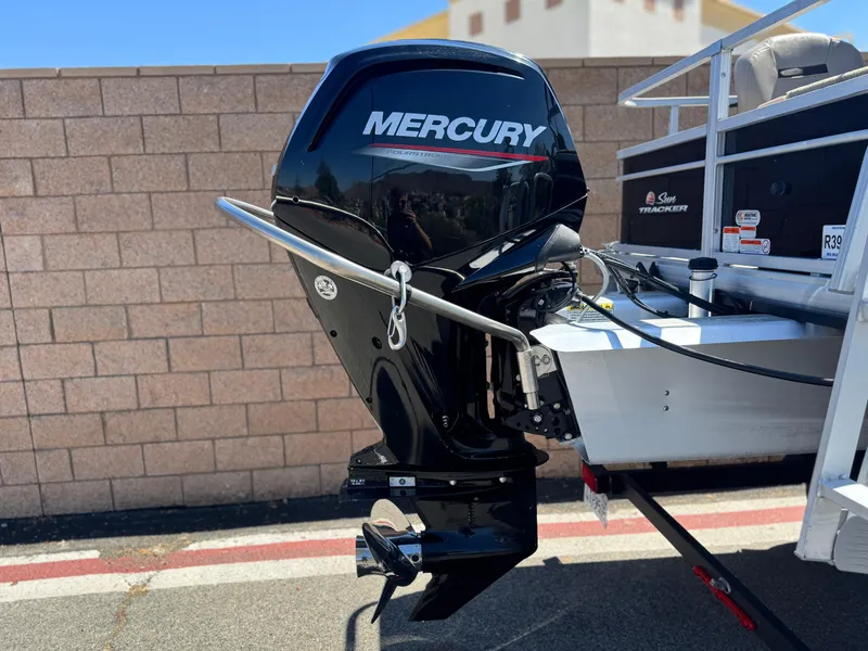 Slide: The Image of 2019 Sun Tracker Fishin' Barge 20 DLX with Mercury outboard motor, parked on trailer. - 6
