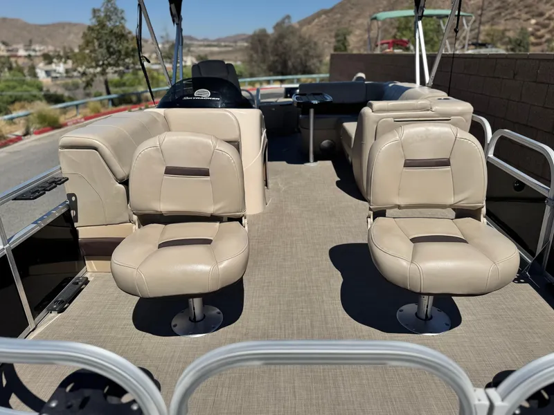 Slide: The Image of 2019 Sun Tracker Fishin' Barge 20 DLX interior with beige seating and open deck layout. - 7