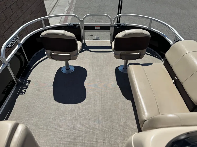 Slide: The Image of 2019 Sun Tracker Fishin' Barge 20 DLX interior with beige seating and spacious deck. - 8