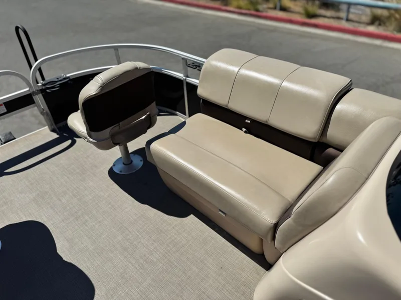 Slide: The Image of 2019 Sun Tracker Fishin' Barge 20 DLX interior with beige seating and carpeted floor. - 9