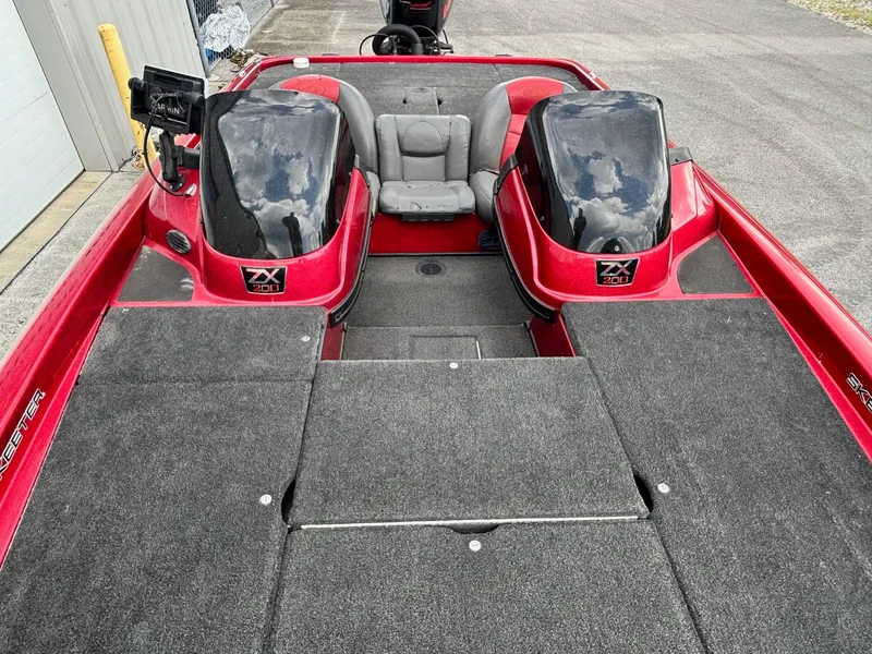 Slide: The Image of 2007 Skeeter ZX 200 boat interior with red and black design, dual consoles, and seating. - 5