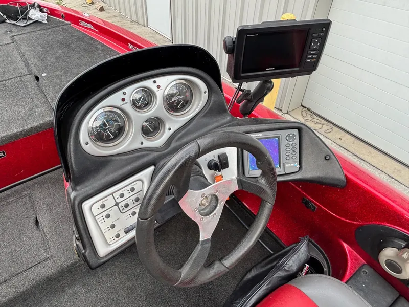 Slide: The Image of 2007 Skeeter ZX 200 boat dashboard with steering wheel, gauges, and electronic displays. - 7