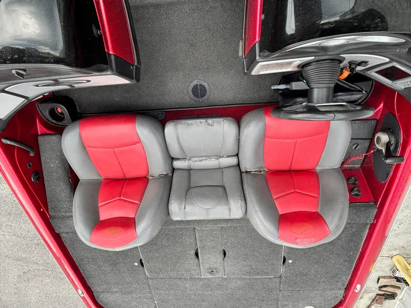 Slide: The Image of 2007 Skeeter ZX 200 boat interior with red and gray seats, steering wheel, and carpeted floor. - 8