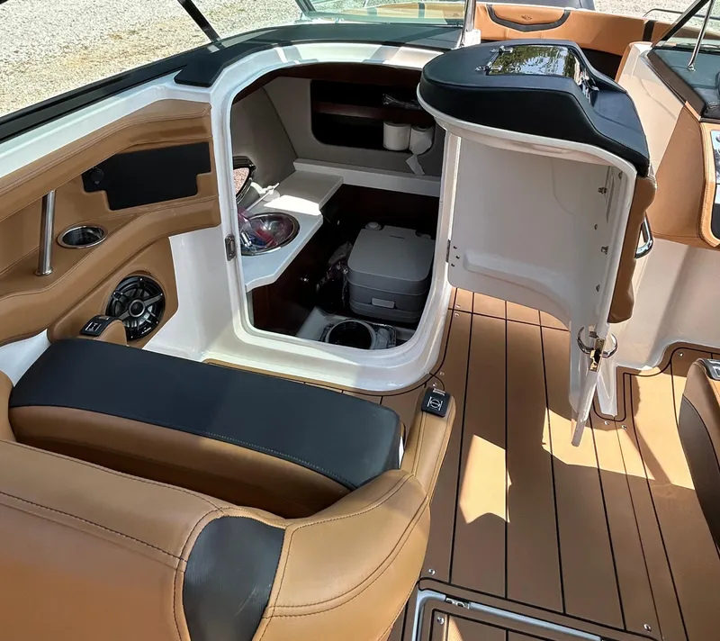 Slide: The Image of 2022 Chaparral 307 SSX boat interior with seating and storage area. - 10