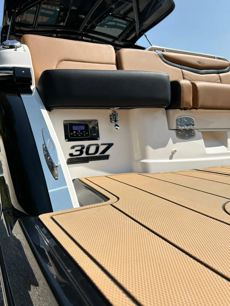 Slide: The Image of 2022 Chaparral 307 SSX boat with tan seating and deck, showcasing luxury design. - 11