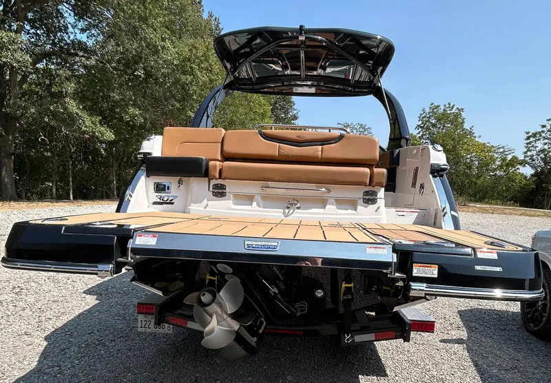 Slide: The Image of 2022 Chaparral 307 SSX boat rear view with swim platform and seating. - 4