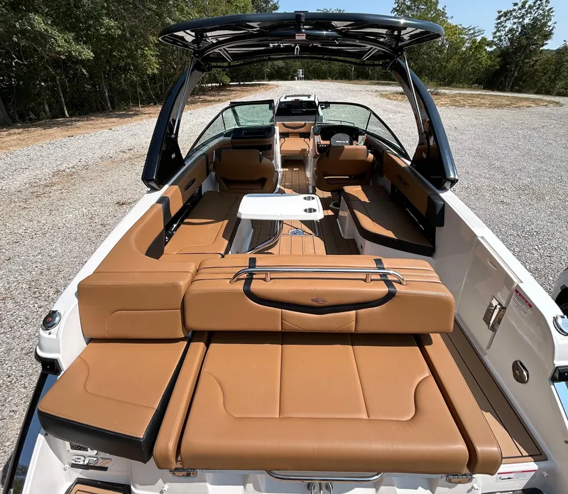 Slide: The Image of 2022 Chaparral 307 SSX boat interior with tan seating and sleek design. - 5