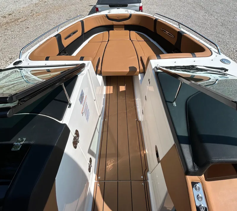 Slide: The Image of 2022 Chaparral 307 SSX boat interior with tan seating and sleek design. - 6