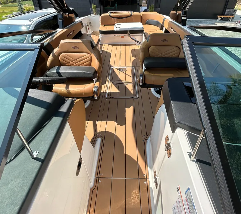 Slide: The Image of 2022 Chaparral 307 SSX boat interior with tan leather seating and sleek design. - 7