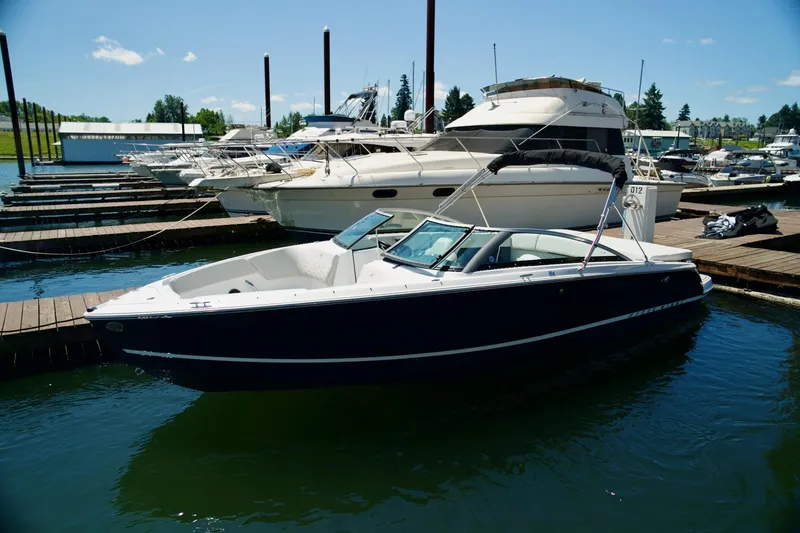 The Image of 2026 Four Winns H4 boat docked at a marina under clear blue skies. - 1