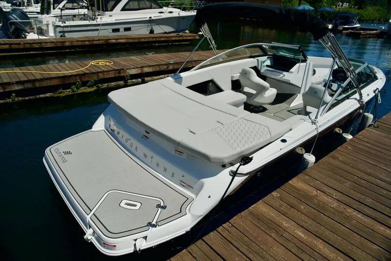 Slide: The Image of 2026 Four Winns H4 boat docked, featuring sleek design and spacious seating. - 10