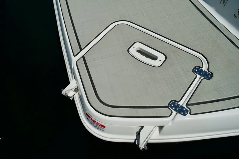 Slide: The Image of 2026 Four Winns H4 boat deck with hatch and hinges, viewed from above. - 11