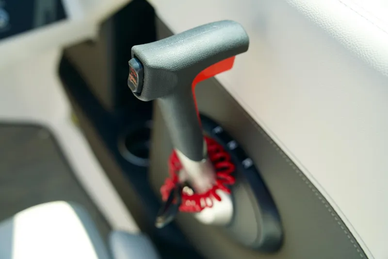 Slide: The Image of Throttle control lever in a 2026 Four Winns H4 boat interior. - 13