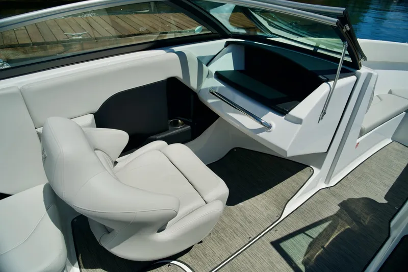 Slide: The Image of 2026 Four Winns H4 boat interior with sleek white seating and modern dashboard design. - 16