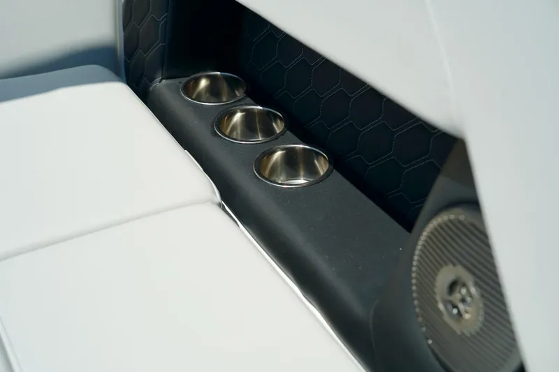 Slide: The Image of 2026 Four Winns H4 boat interior with cup holders and speaker detail. - 19