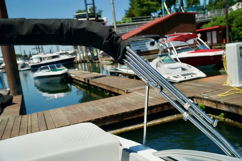 Slide: The Image of 2026 Four Winns H4 boat docked at a marina with other boats. - 24