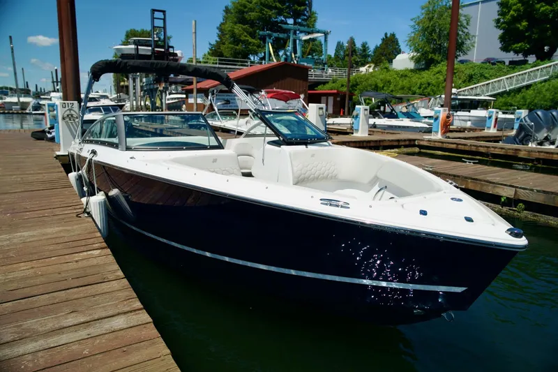 Slide: The Image of 2026 Four Winns H4 boat docked at a marina on a sunny day. - 3