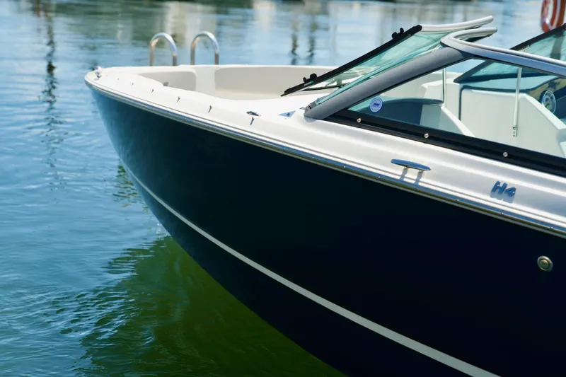 Slide: The Image of 2026 Four Winns H4 boat on calm water, showcasing sleek design and modern features. - 4