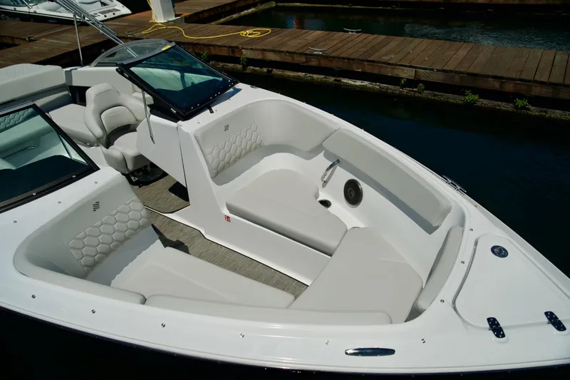 Slide: The Image of 2026 Four Winns H4 boat interior with sleek seating and modern design at a dock. - 5