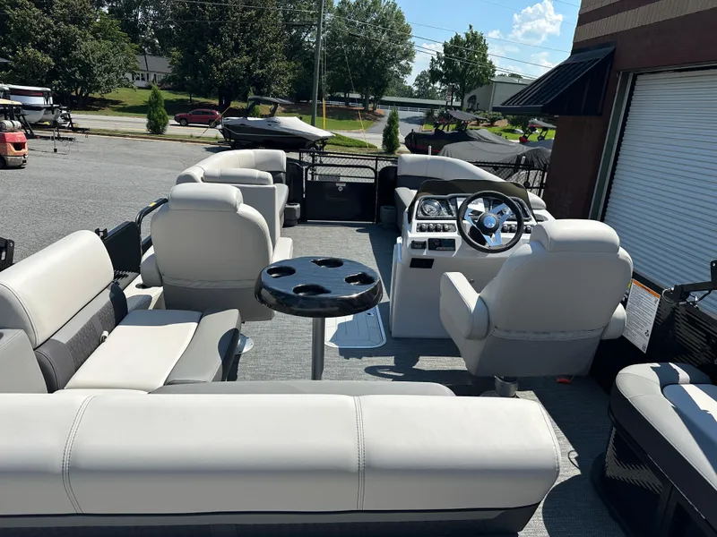Slide: The Image of 2022 Godfrey SWEETWATER 2286 SFL pontoon boat interior with plush seating and steering console. - 12