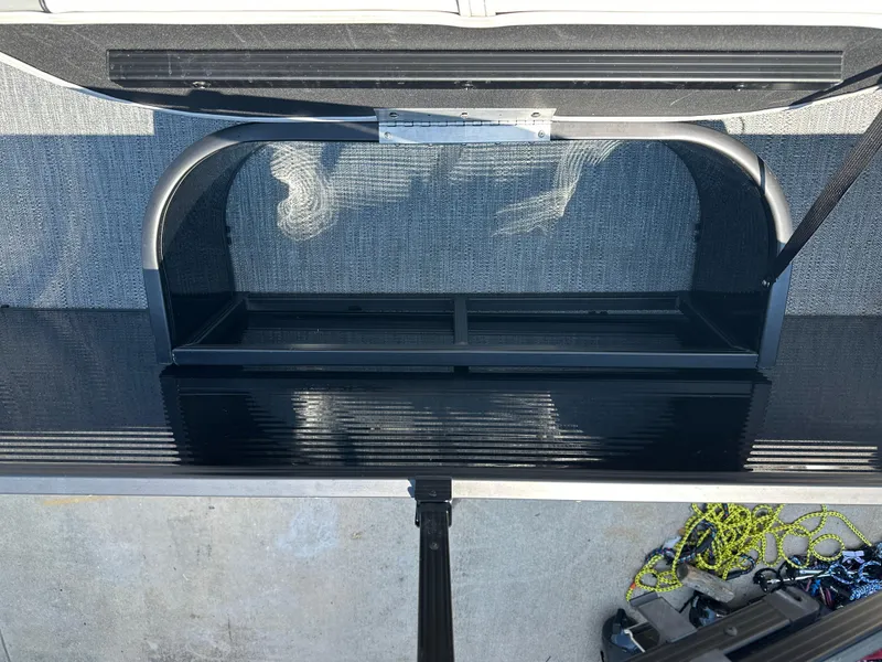 Slide: The Image of Open storage compartment on 2022 Godfrey SWEETWATER 2286 SFL boat, with visible ropes and accessories. - 13