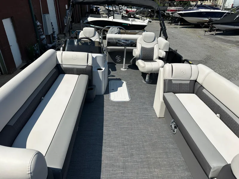 Slide: The Image of 2022 Godfrey SWEETWATER 2286 SFL pontoon boat interior with plush seating and steering console. - 6