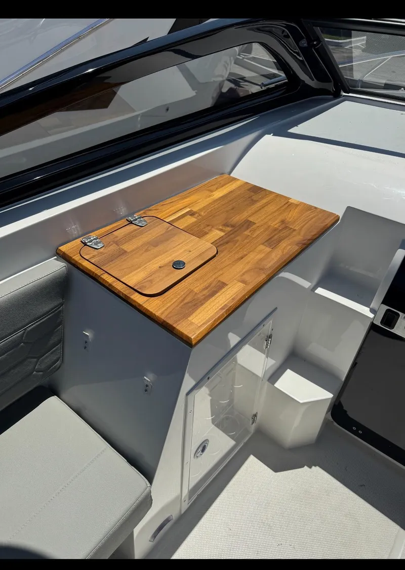 Slide: The Image of 2025 NX Boats NX270 interior with wooden countertop and seating area. - 8