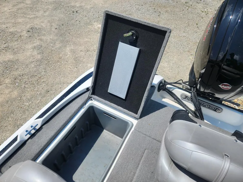 Slide: The Image of 2022 Nitro Z17 boat storage compartment with open lid and visible seating. - 11