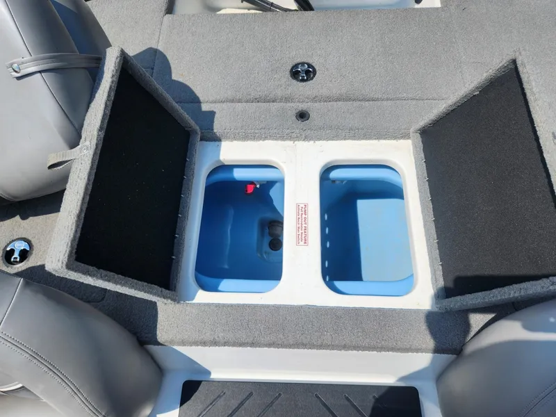 Slide: The Image of Open storage compartment in a 2022 Nitro Z17 boat, featuring dual blue bins. - 12