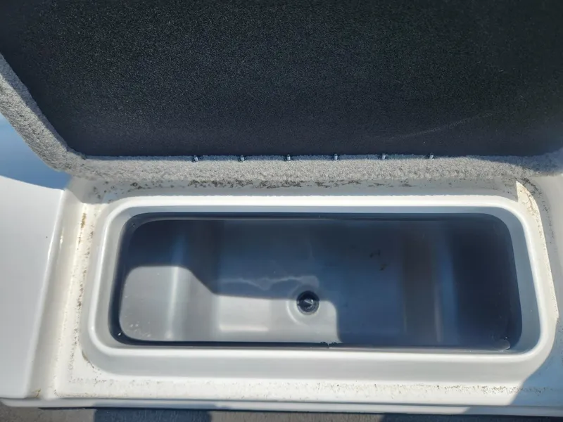 Slide: The Image of Open storage compartment in a 2022 Nitro Z17 boat, showing interior details. - 15