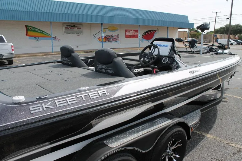 Slide: The Image of 2018 Skeeter ZX250 boat parked outside a dealership, showcasing sleek design and modern features. - 10