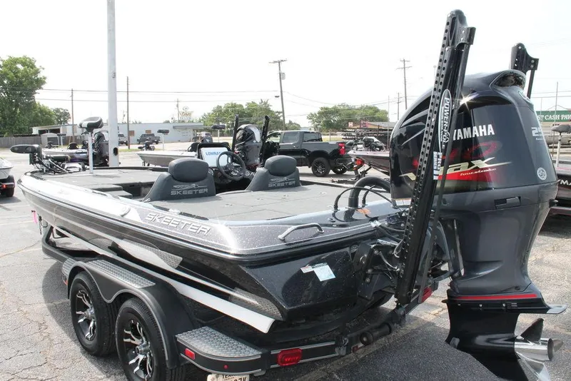 Slide: The Image of 2018 Skeeter ZX250 boat with Yamaha engine, parked on a trailer in a lot. - 4