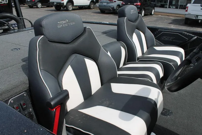 Slide: The Image of 2018 Skeeter ZX250 boat seats with black and white design in a parking lot setting. - 6