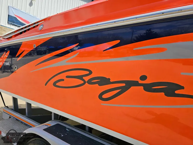Slide: The Image of 2007 Baja 35 Outlaw boat with vibrant orange and black graphics. - 12